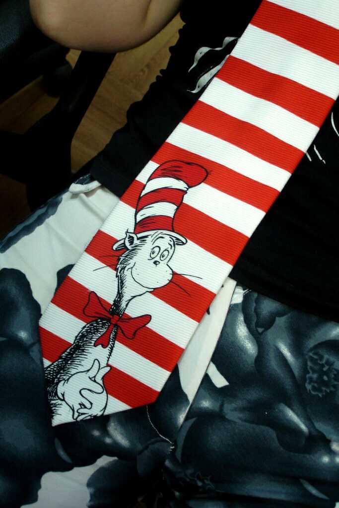 The cat in the hat on my tie on her pants